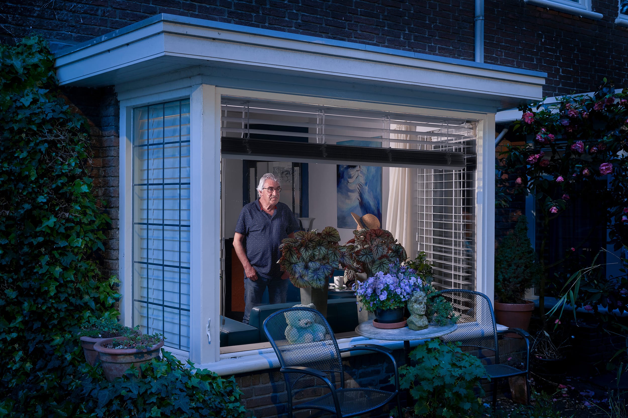 Sjef standing behind the window of his home during lockdown
