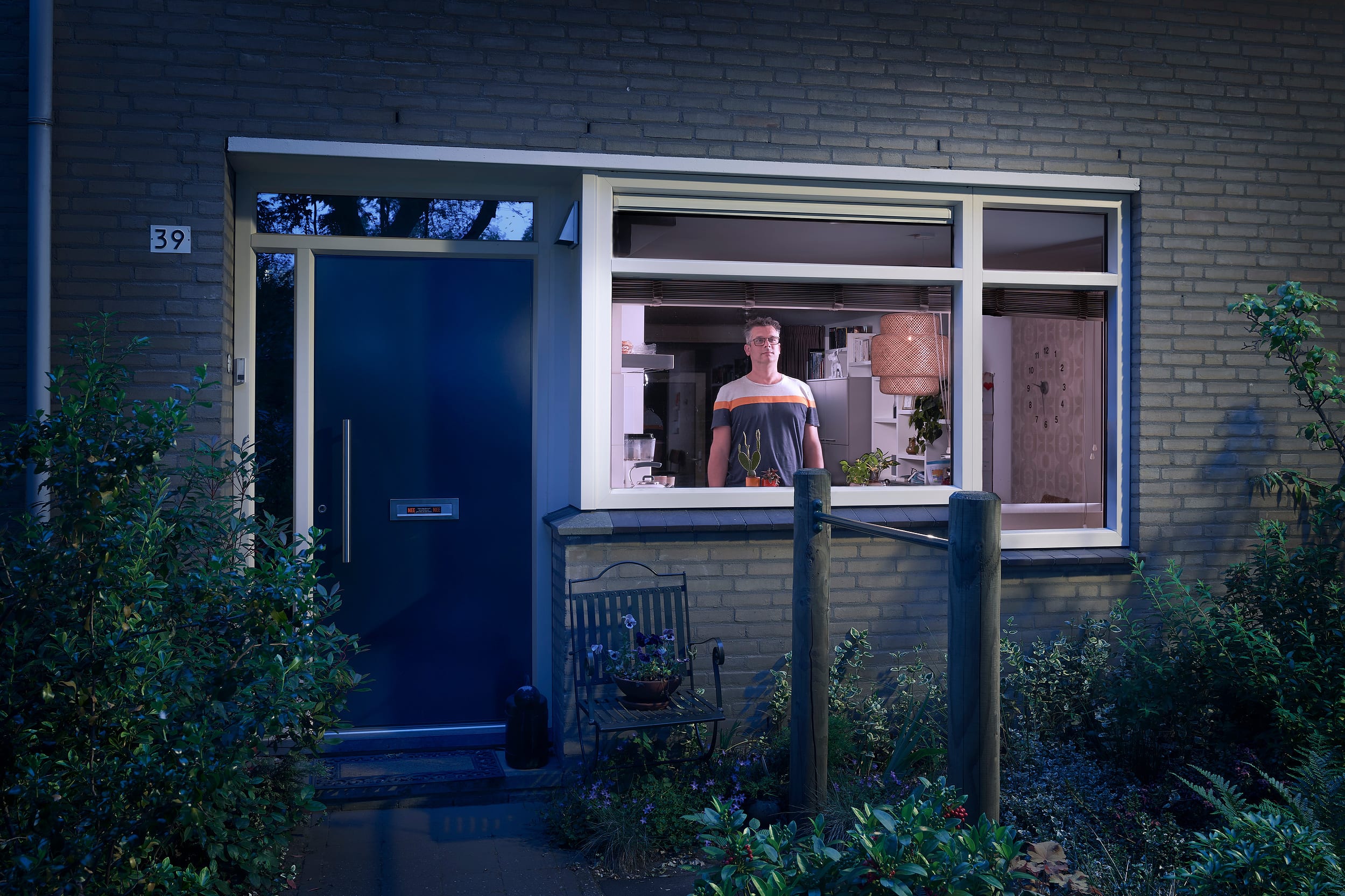 Martijn standing behind the window of his home during lockdown