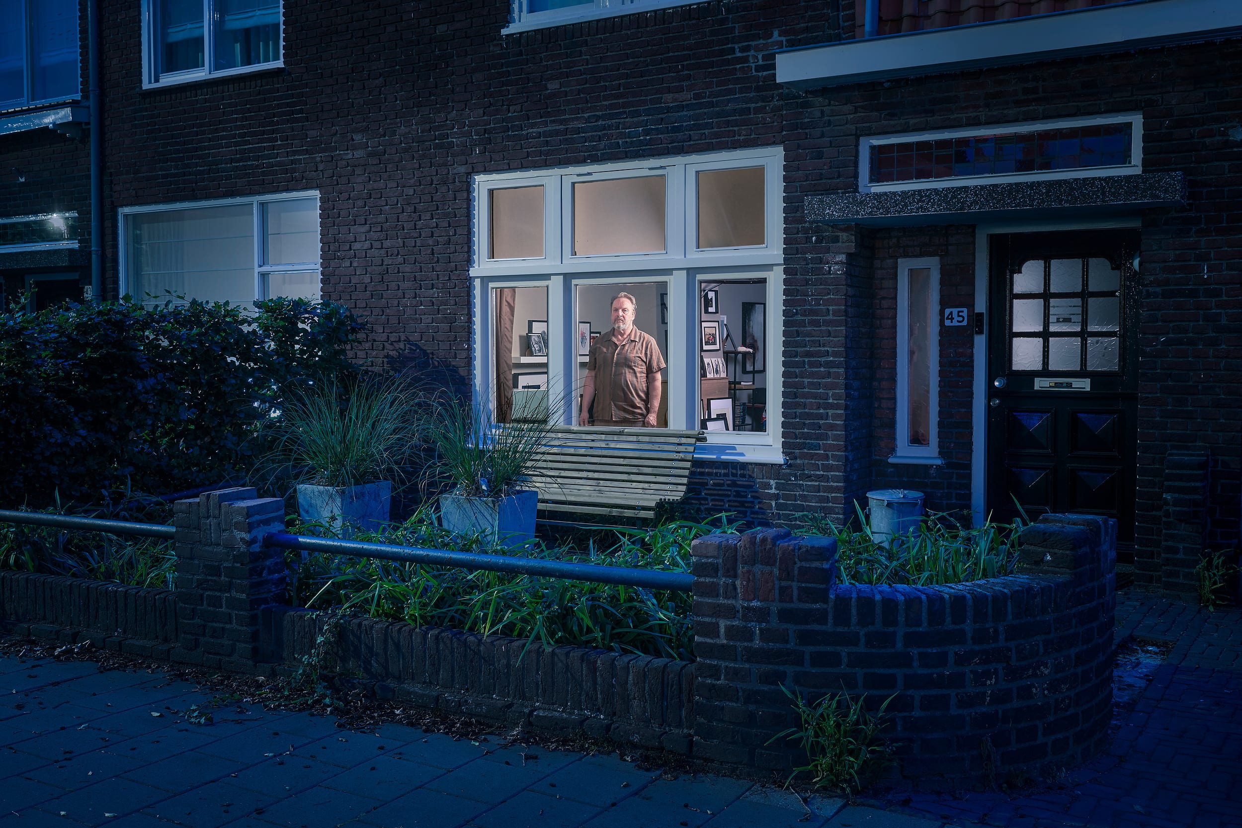 Willem standing behind the window of his home during lockdown