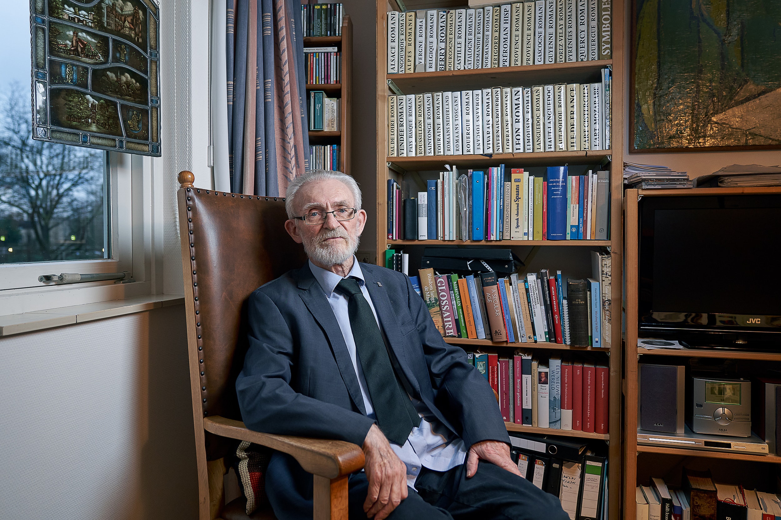 Missionary seated in his room among books and personal objects